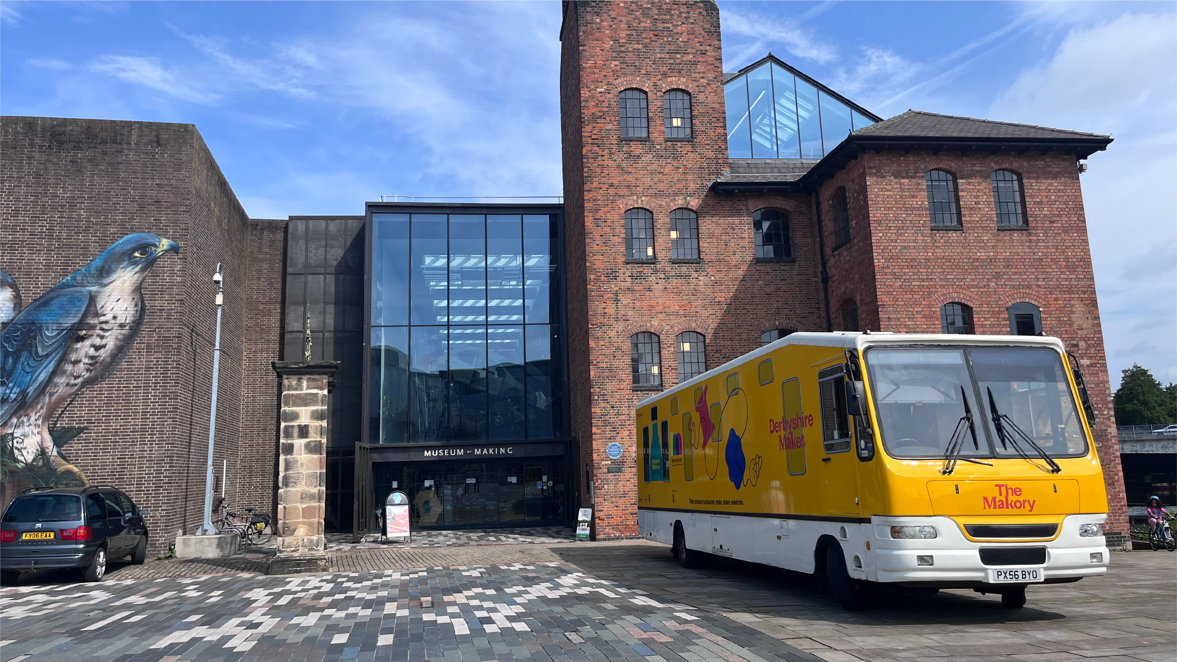 A photograph of the Derby Museums bus called The Makory wrapped with Derbyshire Makes branding advertising the festival and other events.