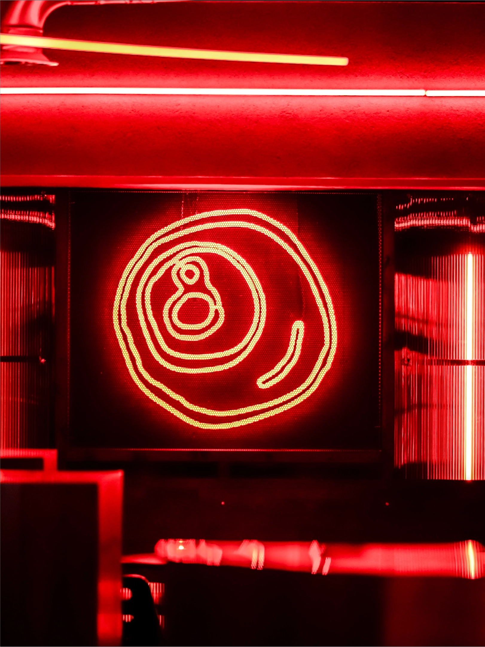 A red star shaped neon light inside the Salon Madre venue created using one of the ink drawn icons from the Salon Madre brand identity by Sanna Studio