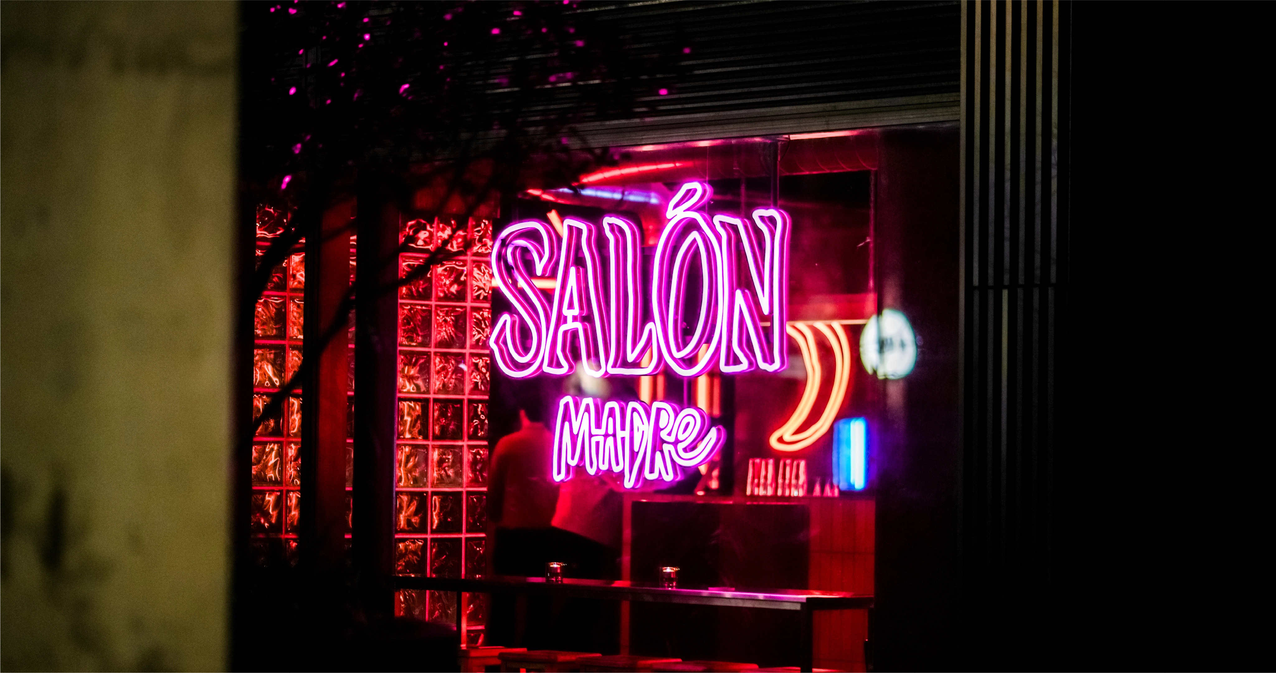 A purple neon light sign of the Salon Madre logo design created during the brand identity project by Sanna Studio