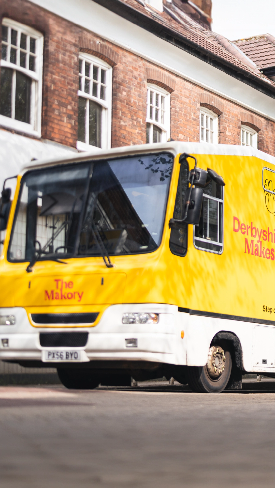 A photograph of the Derby Museums bus called The Makory wrapped with Derbyshire Makes branding advertising the festival and other events.