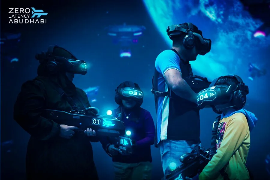 Four players with blasters in front of a space-themed backdrop