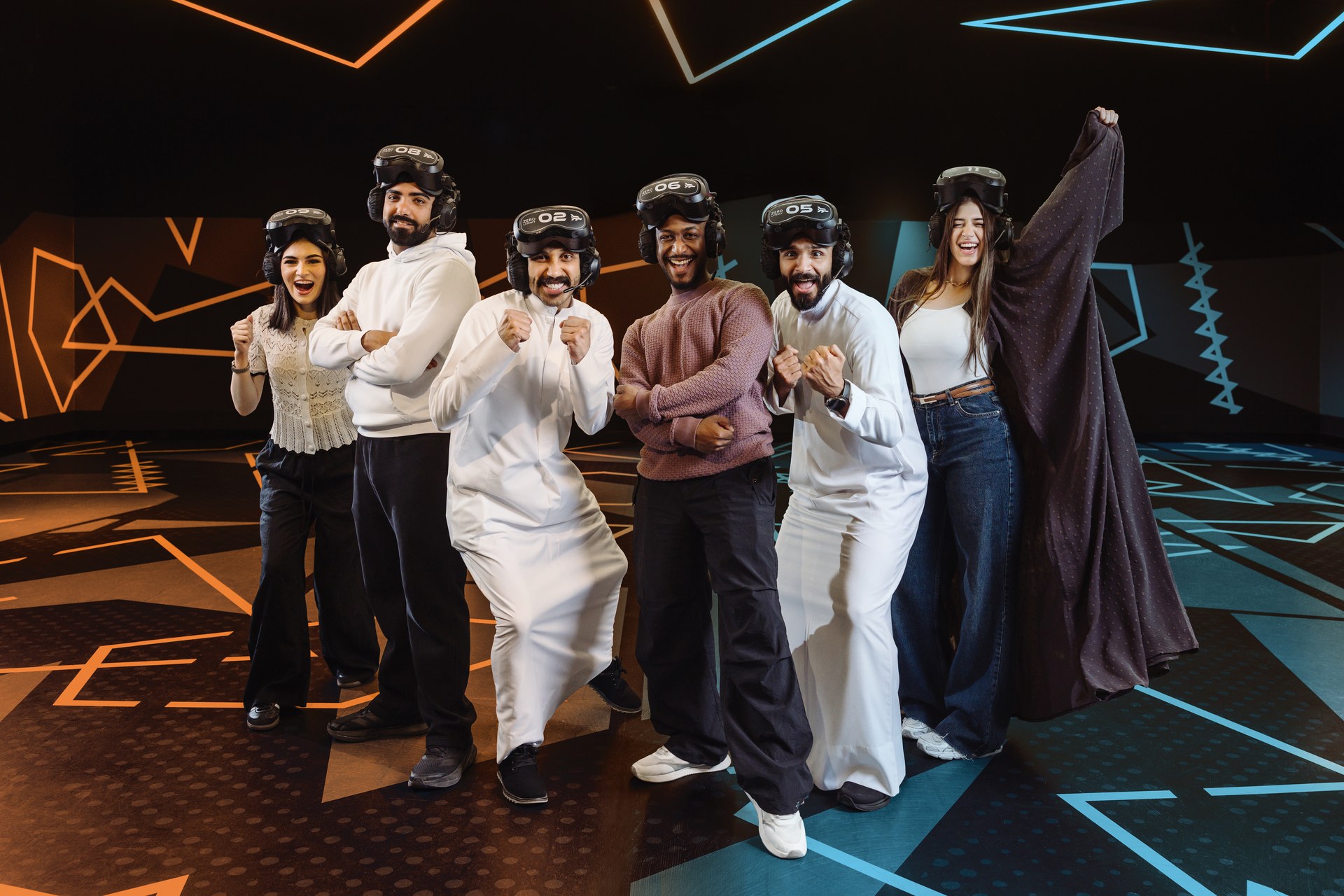 Six players wearing VR headsets pose together in a Zero Latency arena.