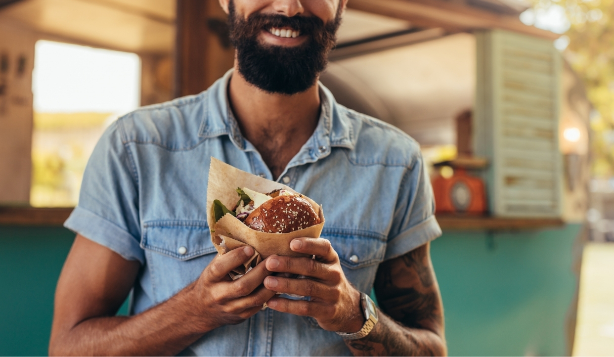 Man smiling with burger.