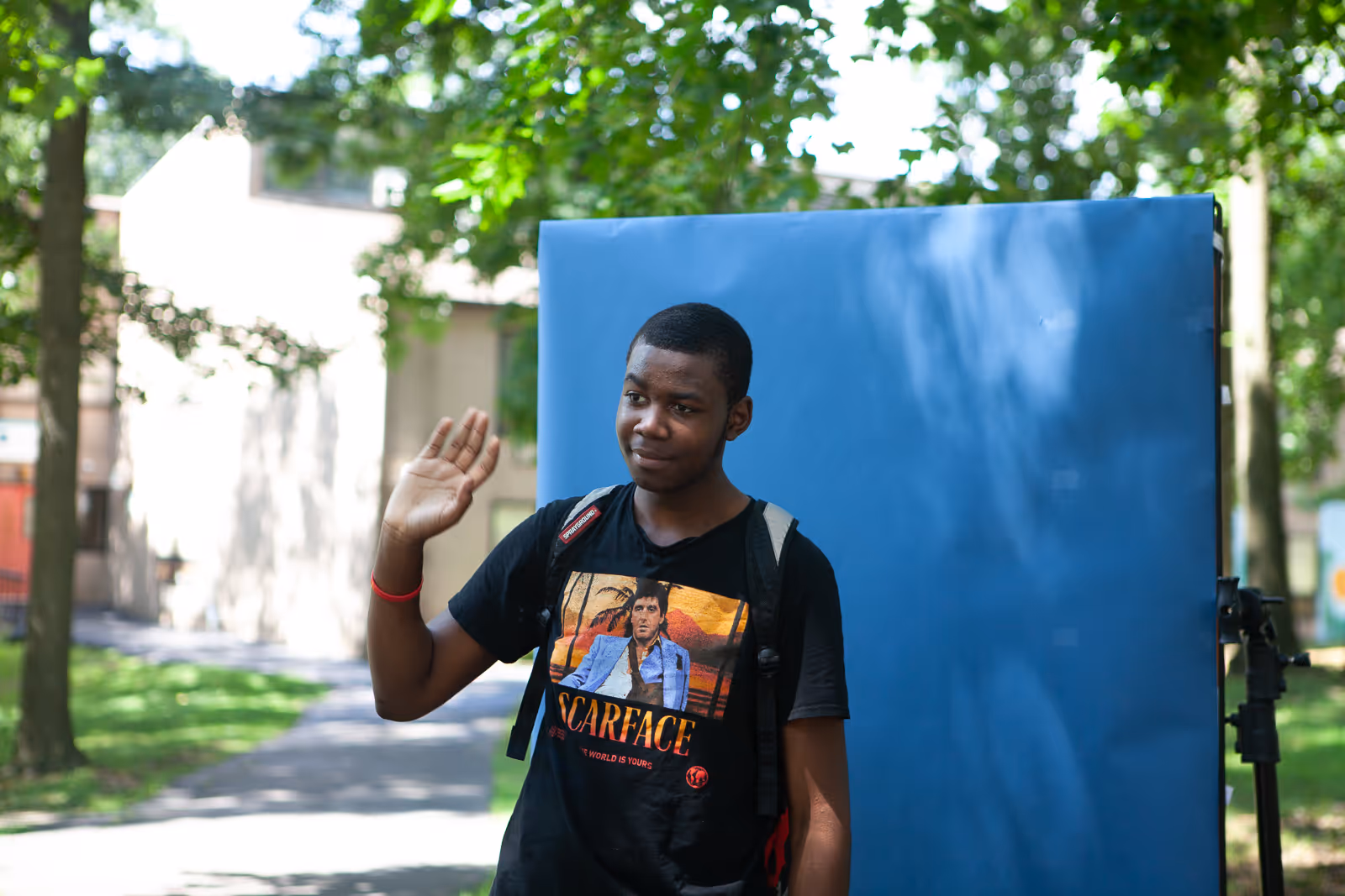 BTS of student waving to camera for Fairwold Academy commercial filmed by Camos Media.