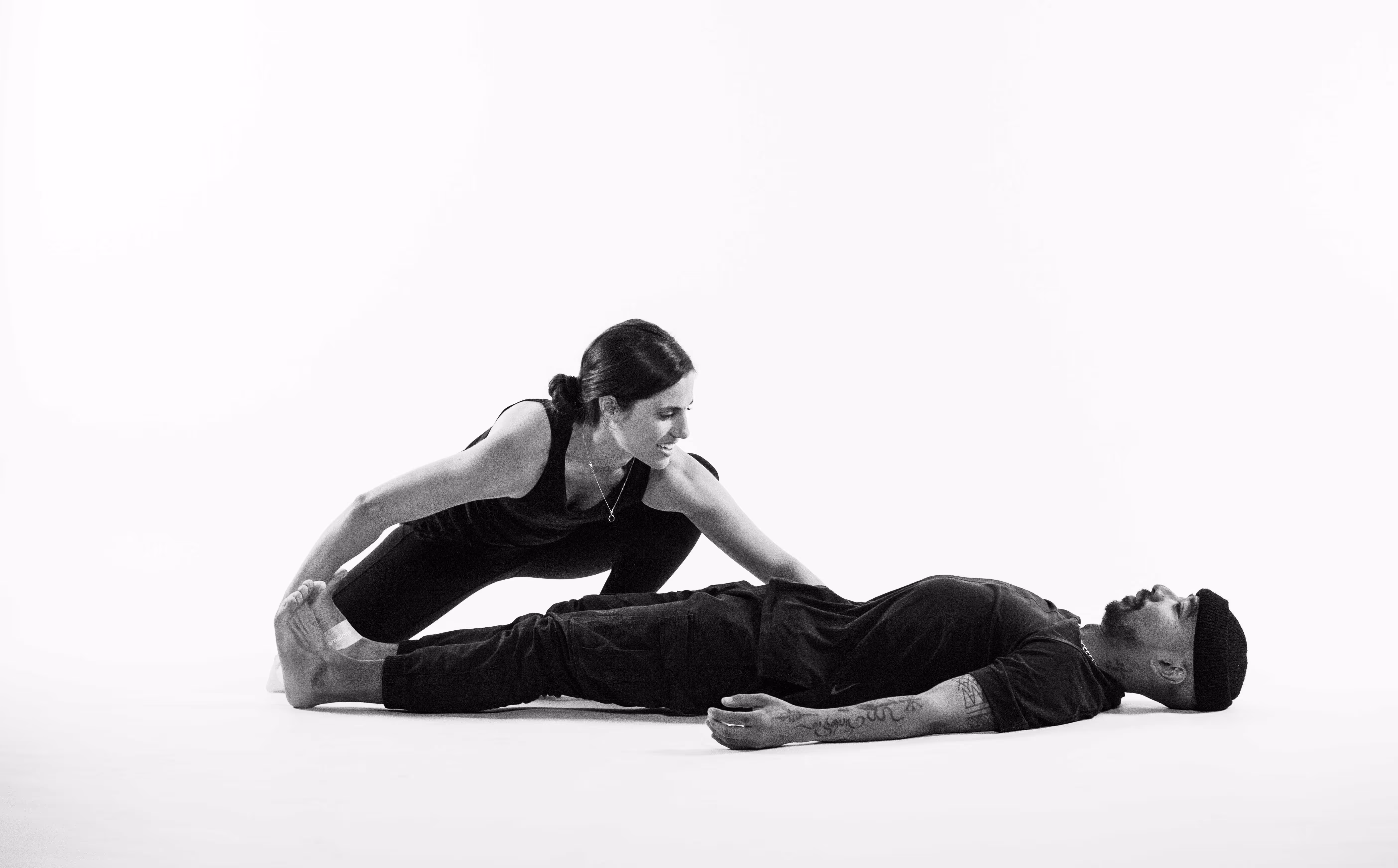 Personal trainer stretching yoga instructor during The Lab branded video filmed by Camos Media.