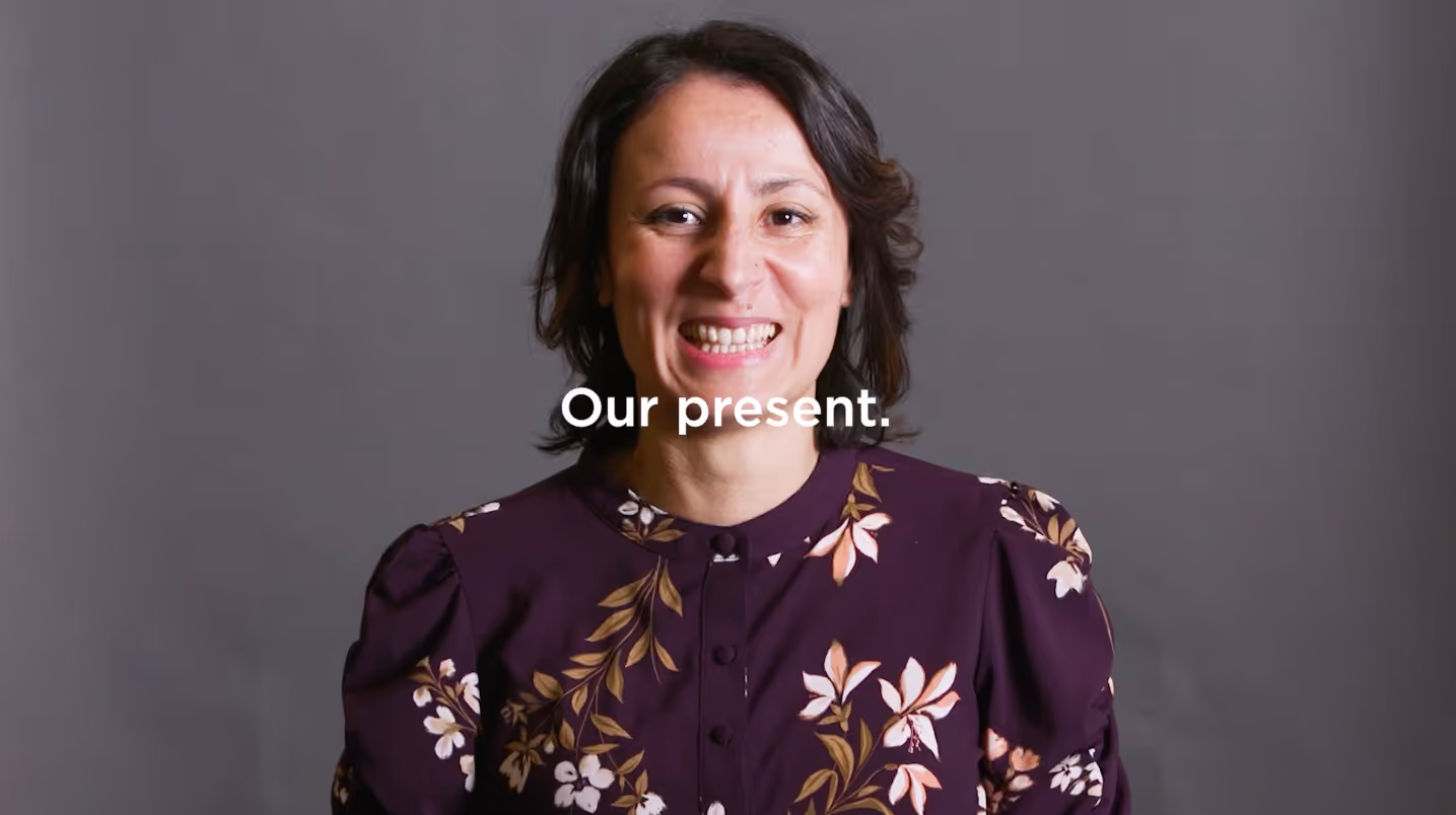 PHMC employee sits in for an interview on a studio lit gray seamless backdrop filmed by Camos Media.