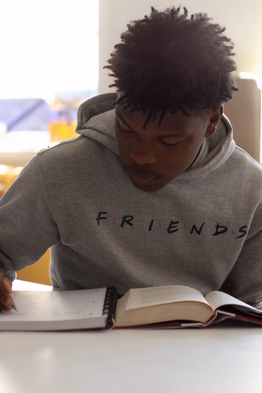 Student taking notes featured in Mill Creek School video filmed by Camos Media.