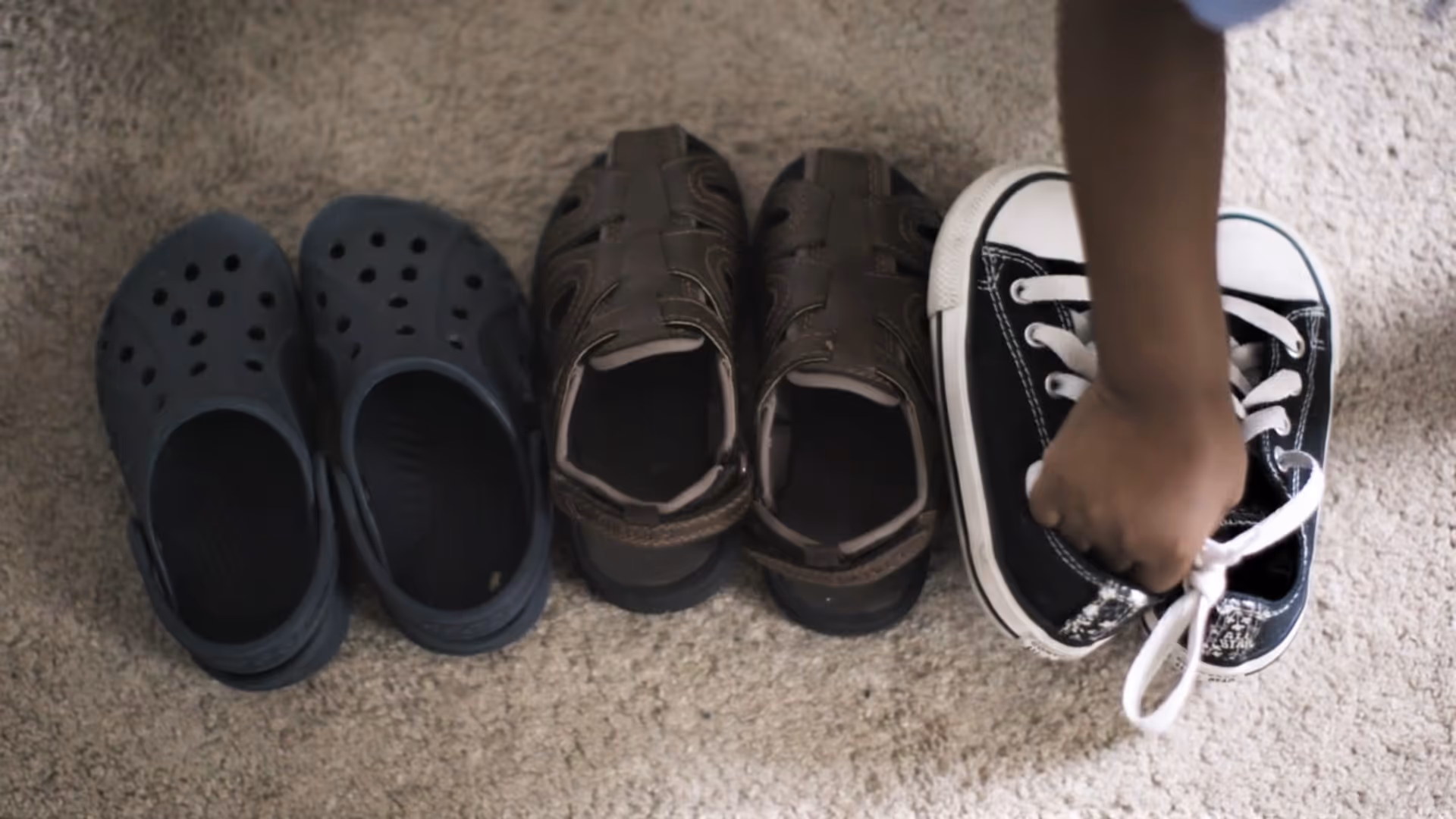 Placing shoes down during Turning Points video featuring the FAWN program filmed by Camos Media. 