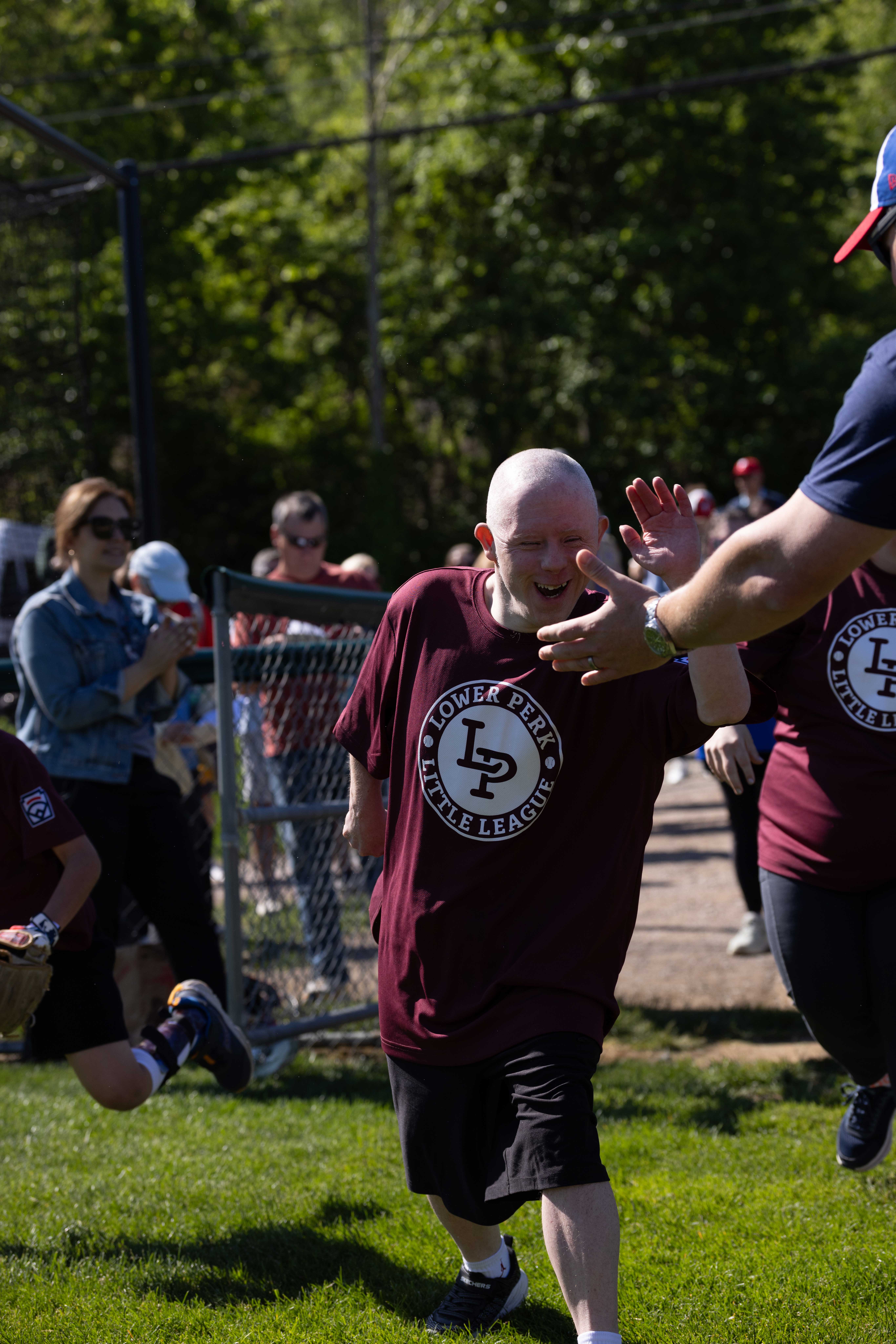 Challenger player high-fiving during Berwyn Paoli Little League Challenger Day.