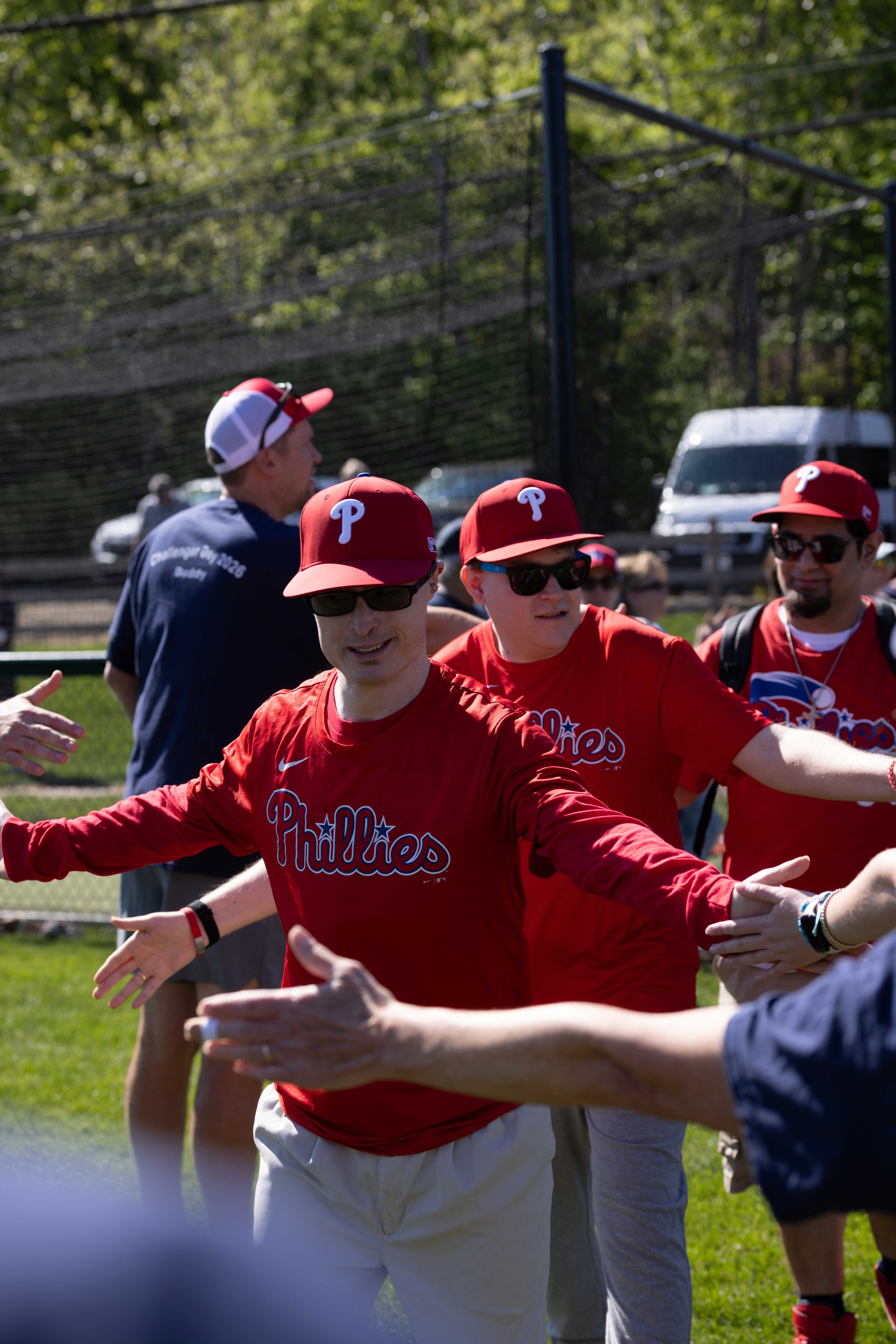 Player wearing a Phillies jersey high-fiving during Berwyn Paoli Little League Challenger Day.