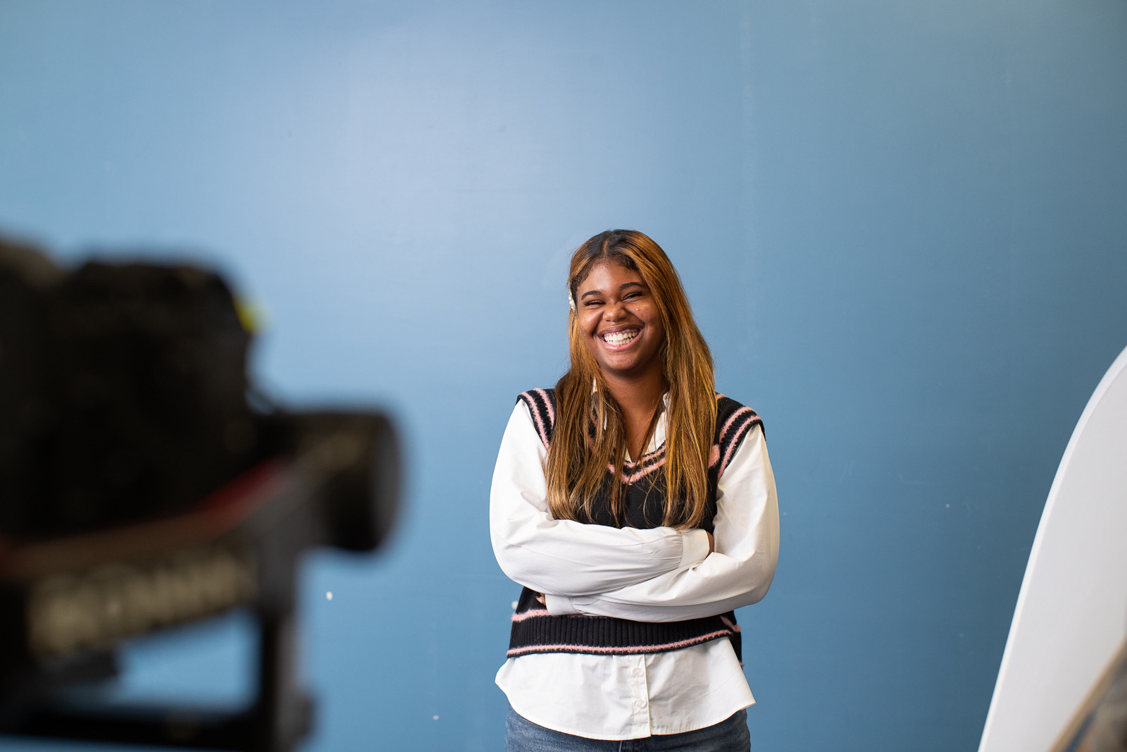 High School student featured on blue backdrop during an I AM SDP commercial filmed by Camos Media. 