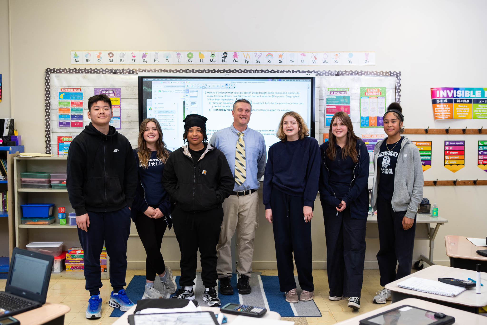 Algebra teacher and students pose at the board during an I AM SDP commercial filmed by Camos Media. 
