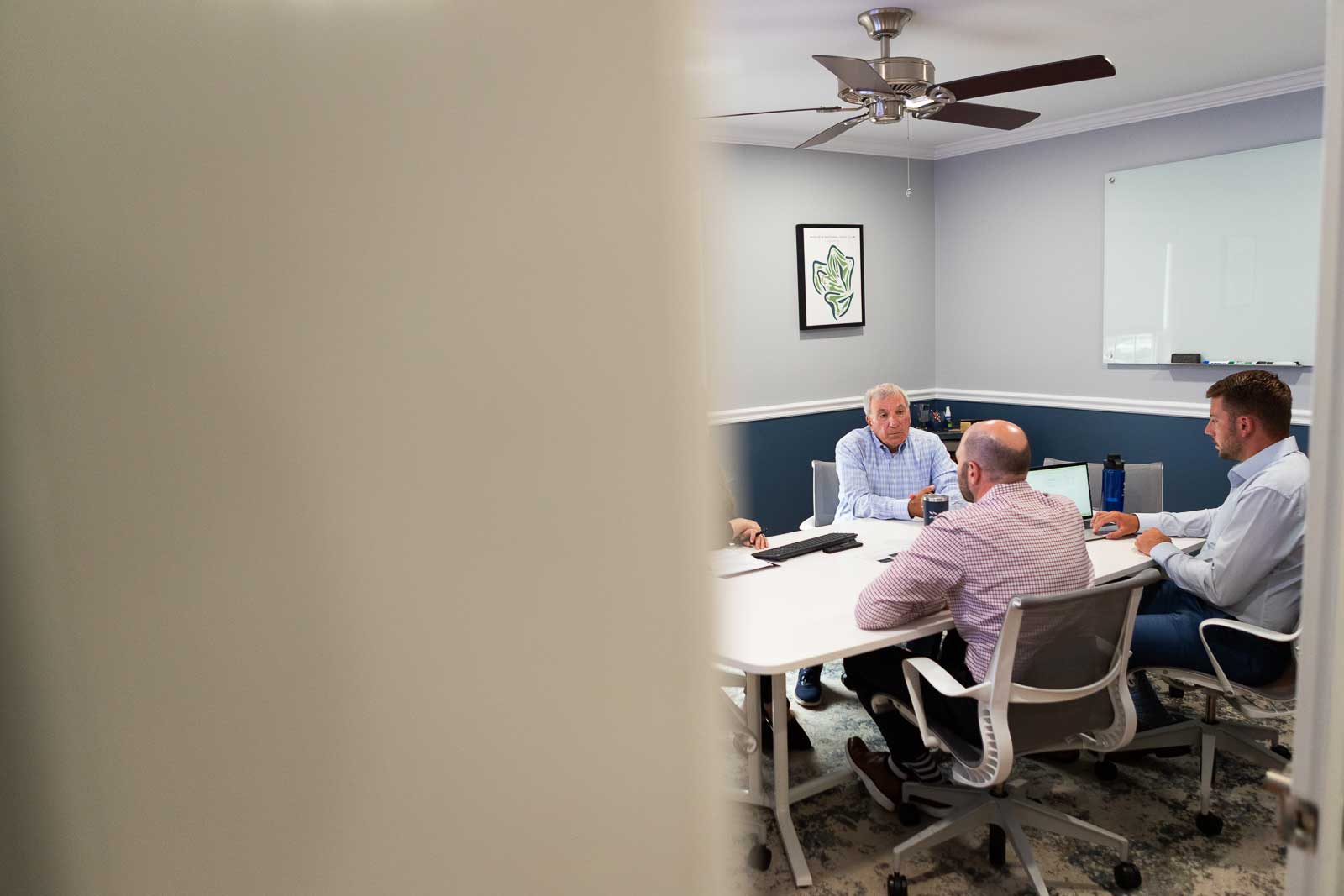 Brand meeting in a bright office captured during production by Camos Media.
