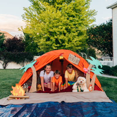 kids in a tent in the backyard on a staycation