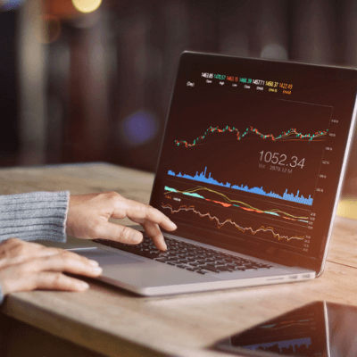 person figuring out the stock market on their computer