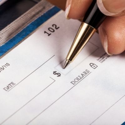 person writing out a check