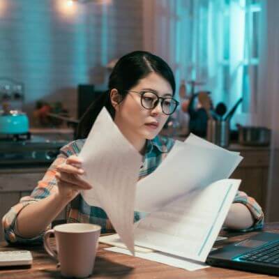 Woman reviewing tax documents at a desk