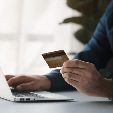 credit utilization ratio, person using a laptop to make an online payment with a credit card