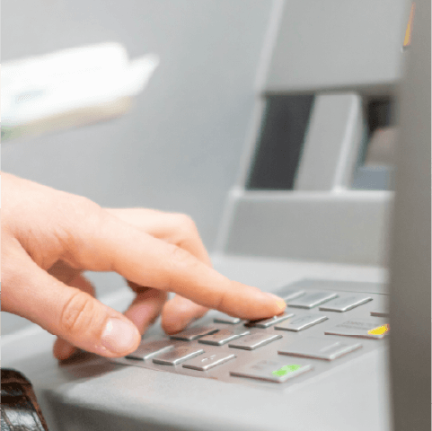 Person withdrawing cash from an ATM