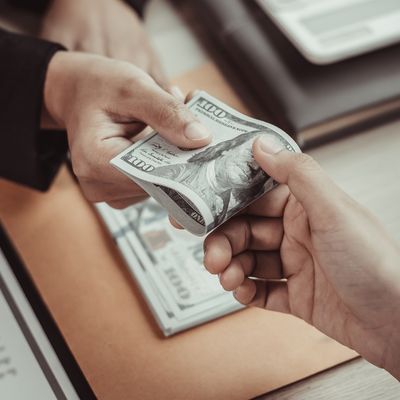 One person handing money to another to represent a loan