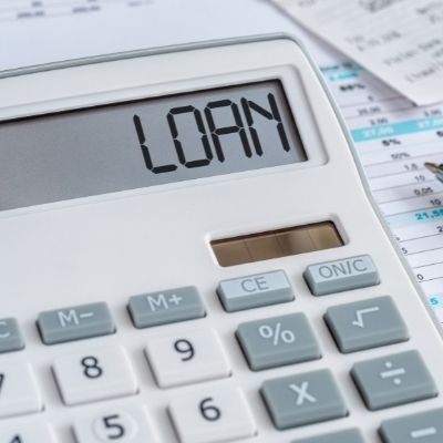 Loan application paperwork with a digital approved checklist