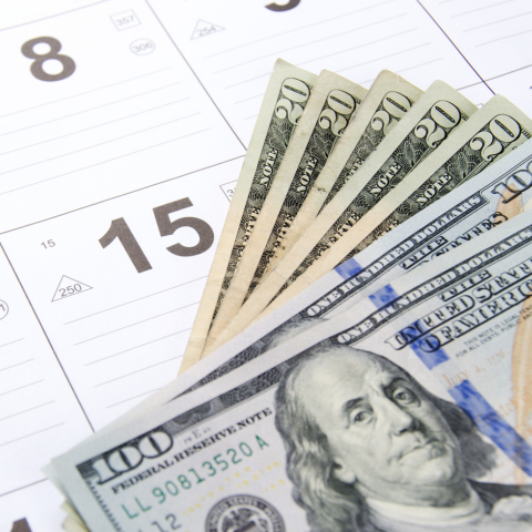 cash on top of a calendar