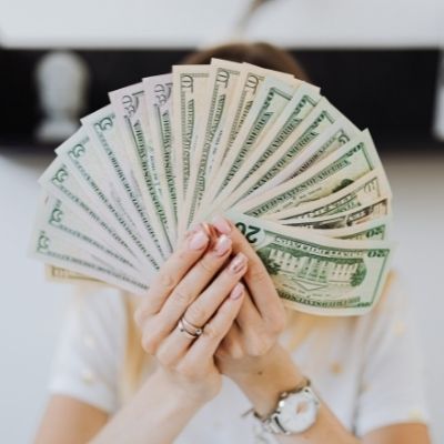 someone holding money establishing gross income