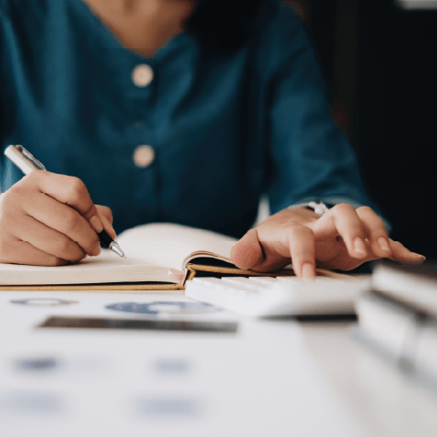 Payment-to-income calculations in a notebook beside a pen
