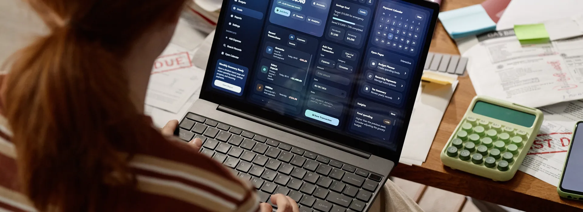 Woman managing household budget on laptop