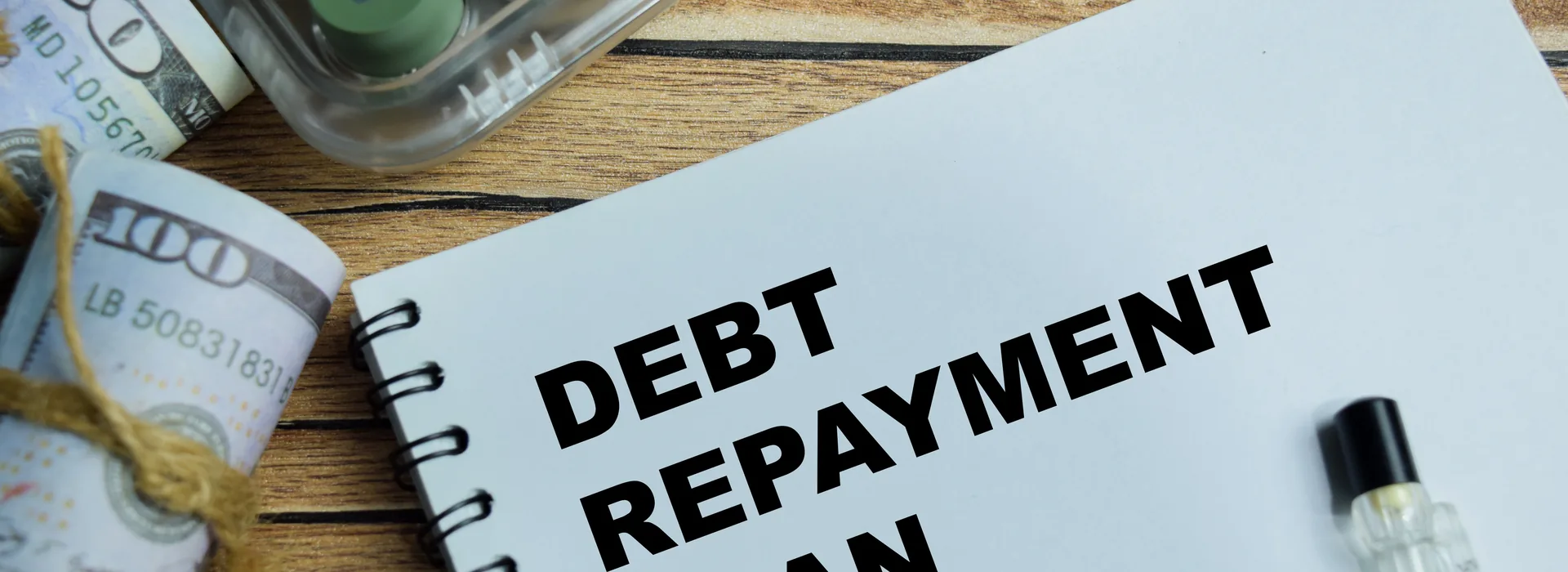 Debt repayment planning write on book isolated on Wooden Table
