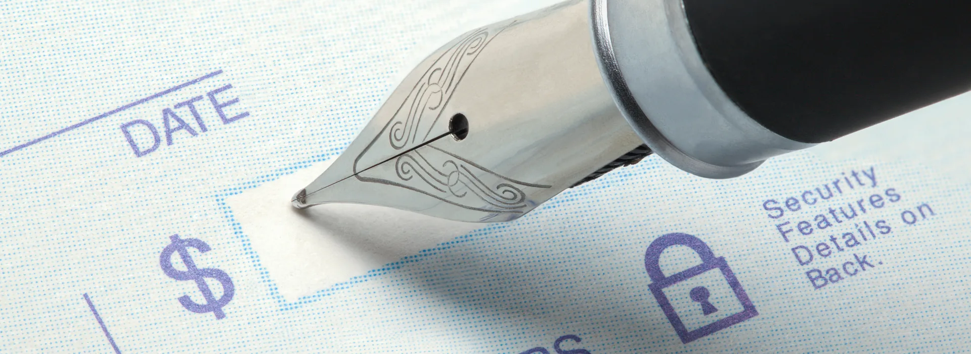 Blank check and pen in close-up