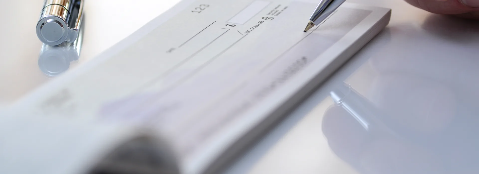 Businessman hand hold pen fill a banque cheque document