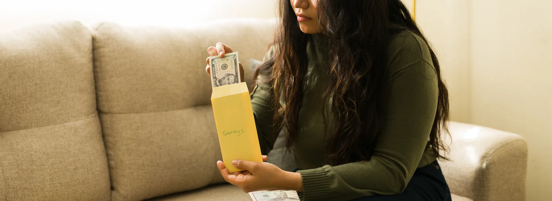 Woman organizing cash into budget envelopes