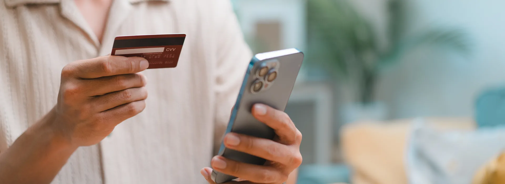 Person using a smartphone and payment card for a digital money transfer