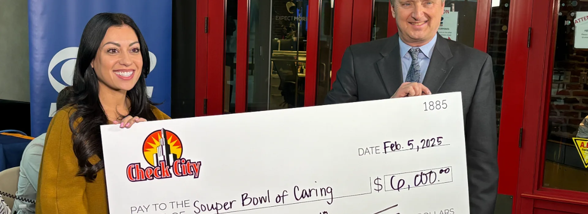 Check City representatives presenting a $6,000 hunger-relief donation check