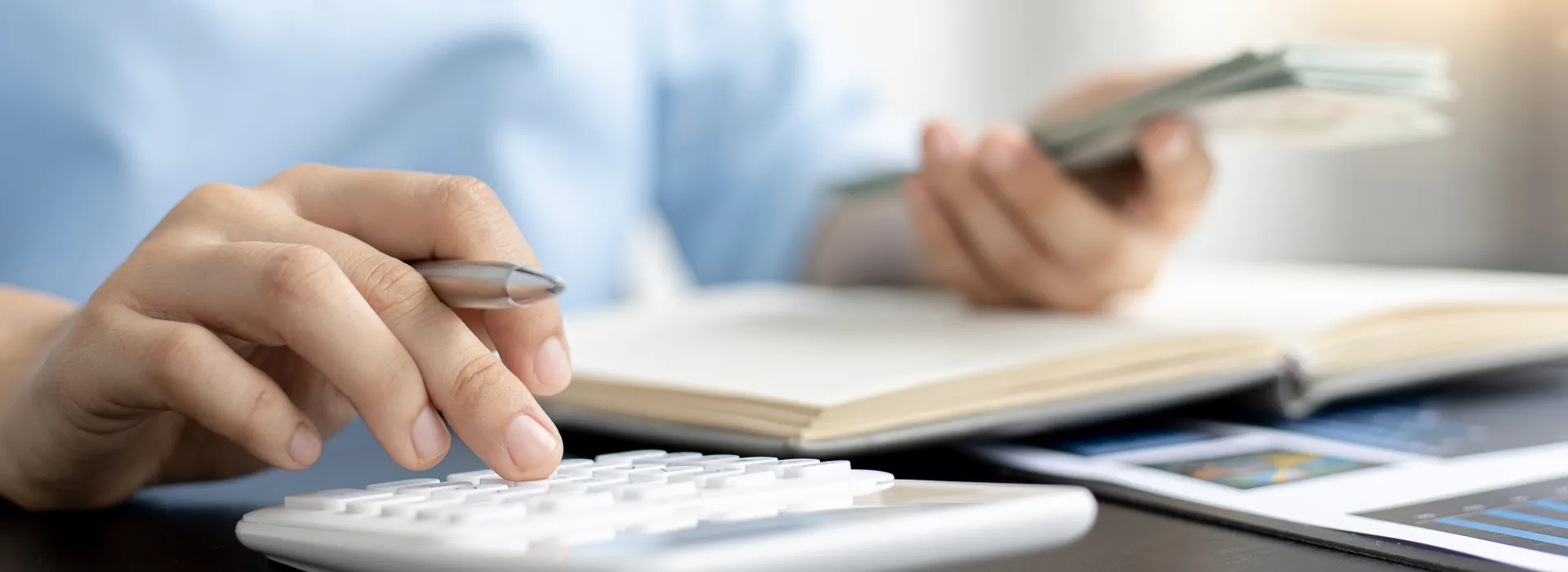 Woman calculating household income and expenses with a calculator