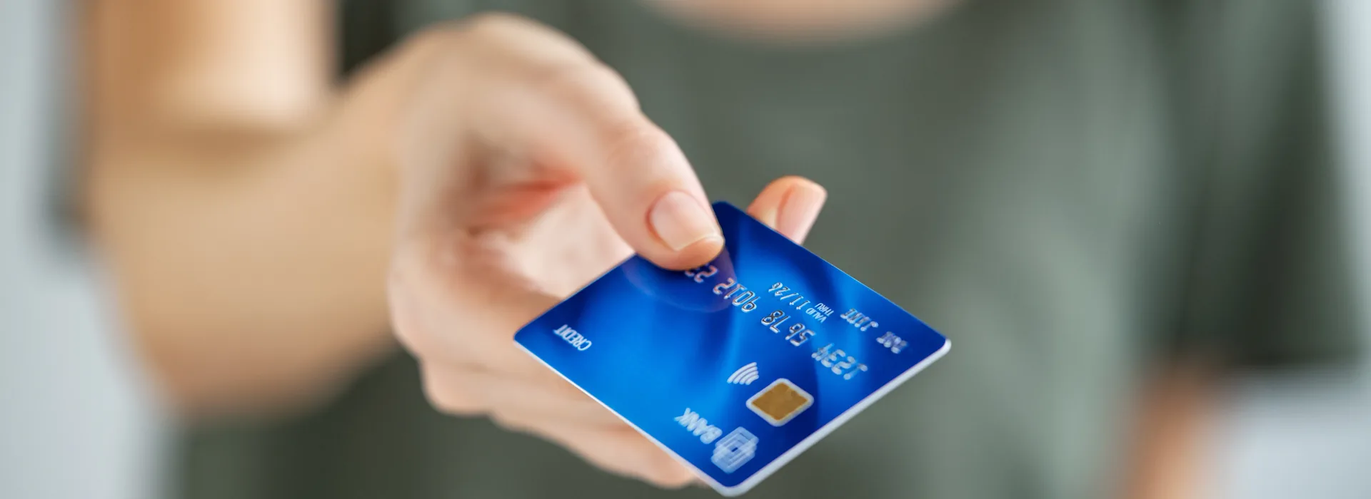 Woman holding a credit card for an authorized user