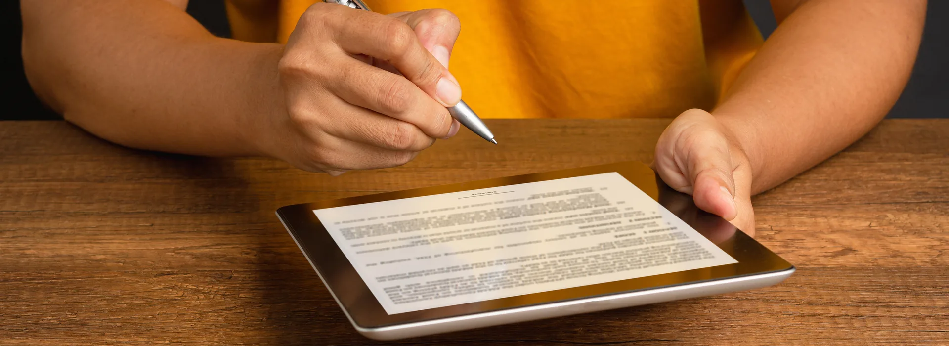 Person signing a payday loan application on a tablet