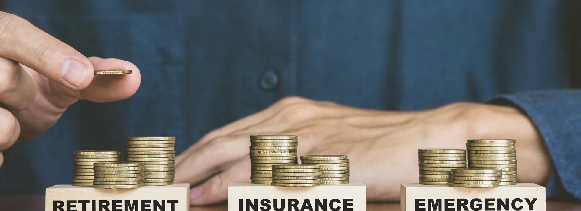Coins divided among retirement, insurance, and emergency savings
