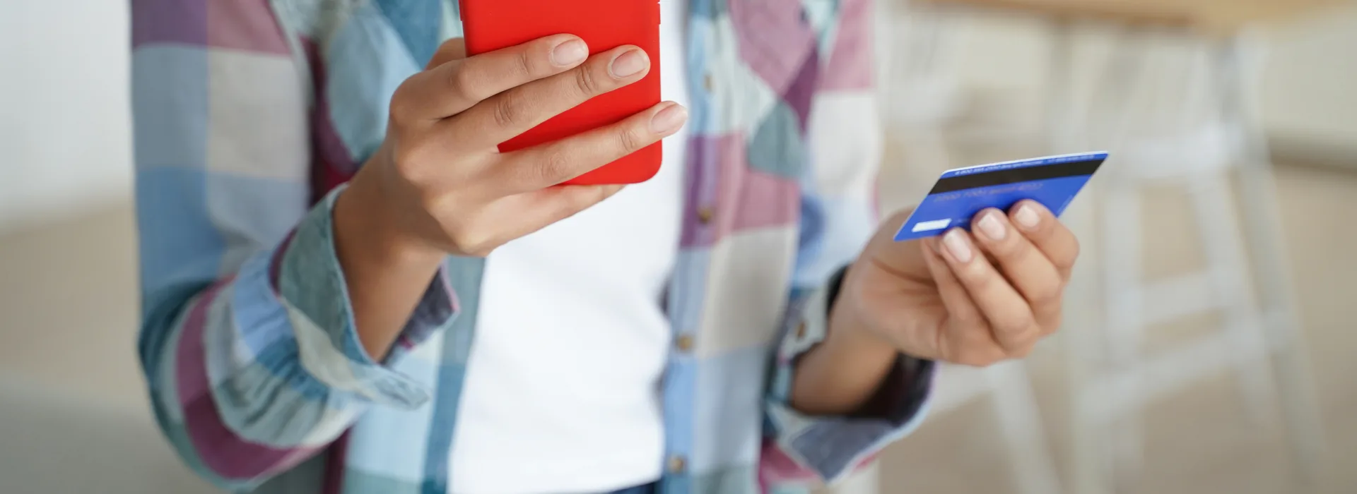 Person using a smartphone and payment card for an online transaction