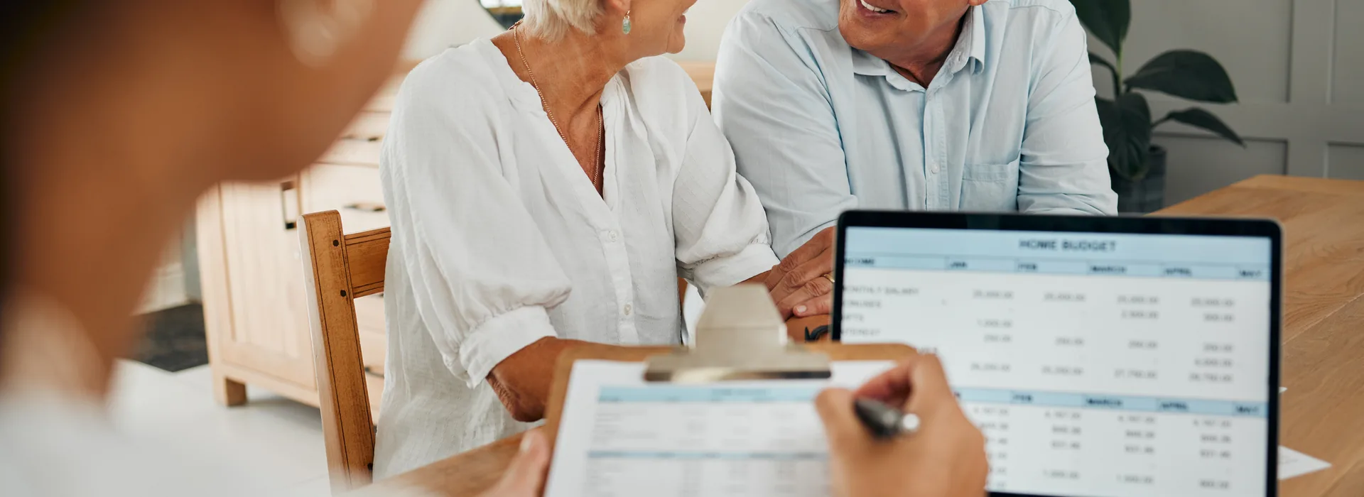 Senior couple reviewing financial paperwork with an advisor
