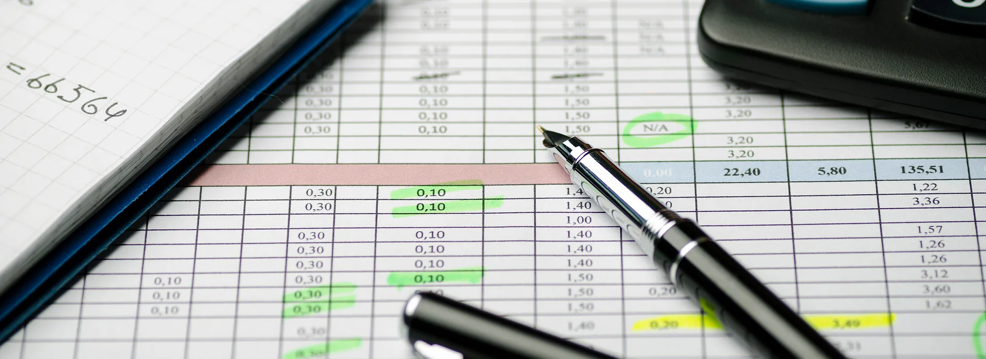 Payment-to-income calculations in a notebook beside a pen