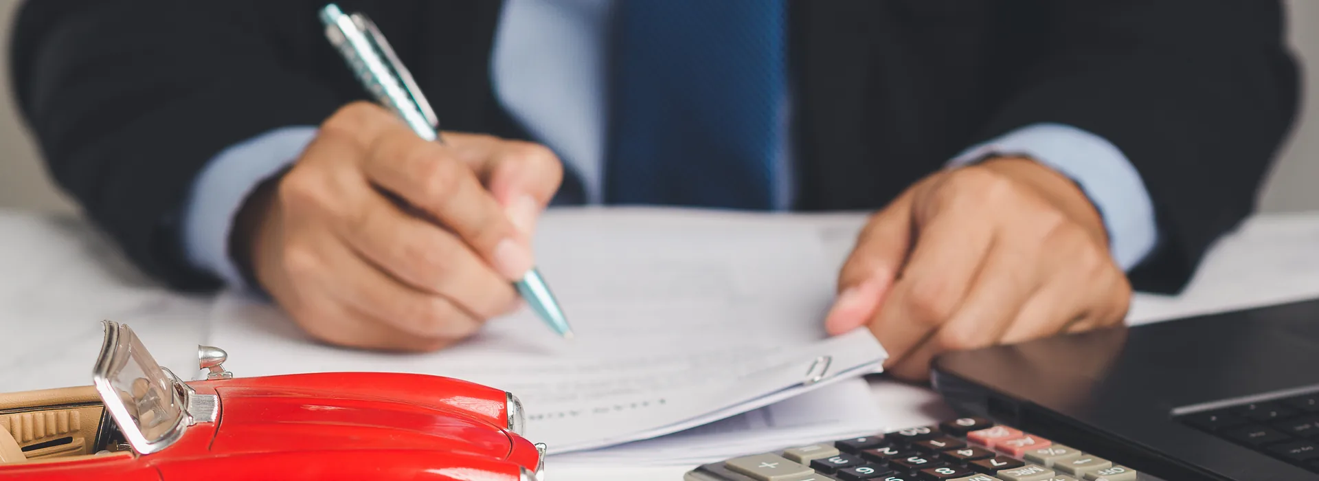 Borrower signing a loan agreement at a desk