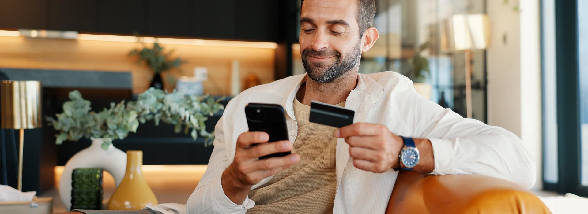 Man using a secured credit card with a smartphone