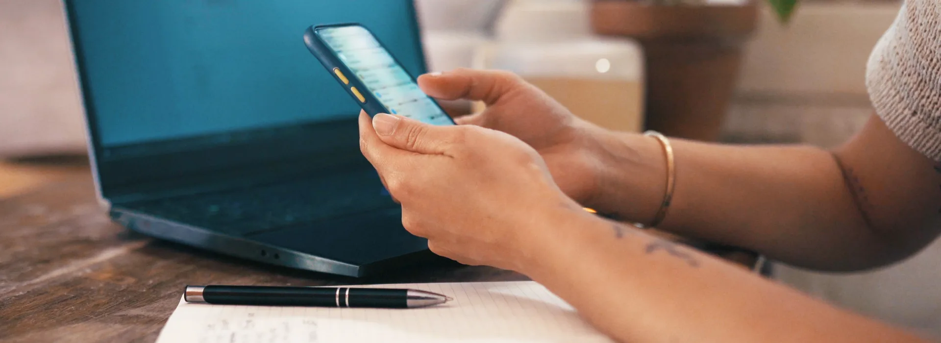 Person researching a small online loan on a smartphone and laptop