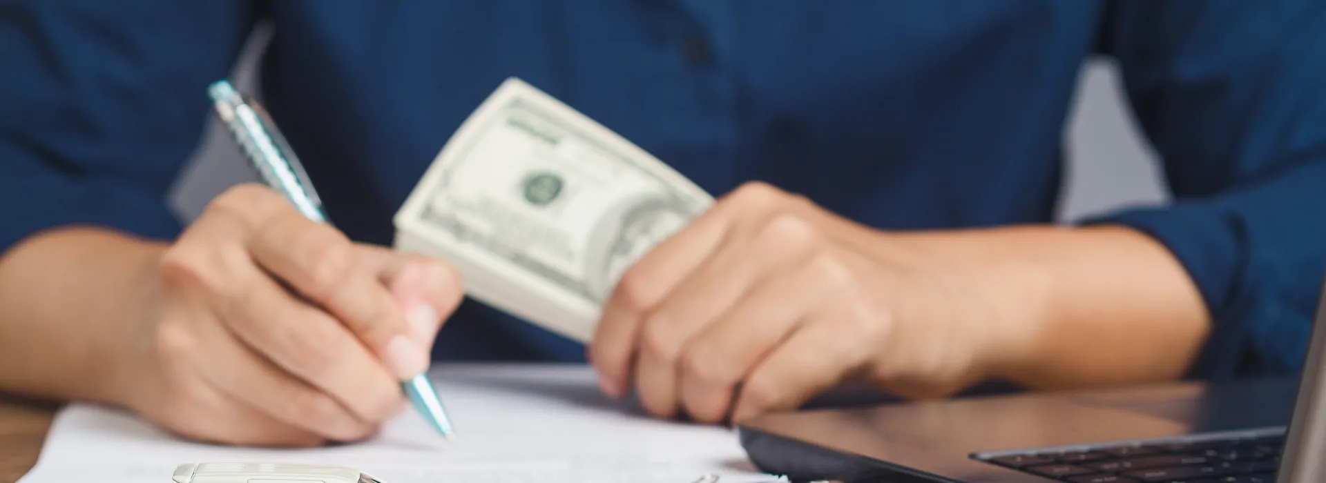 Borrower holding cash while signing a loan agreement
