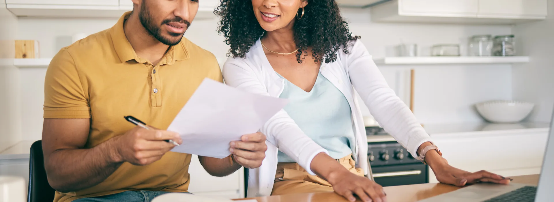 Couple reviewing closing disclosure paperwork at home