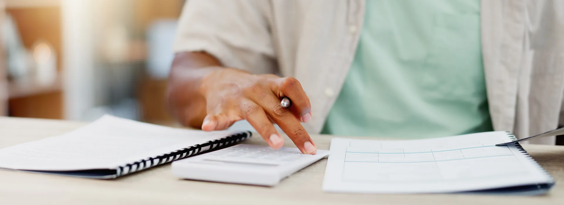 Person reviewing personal loan paperwork with a calculator