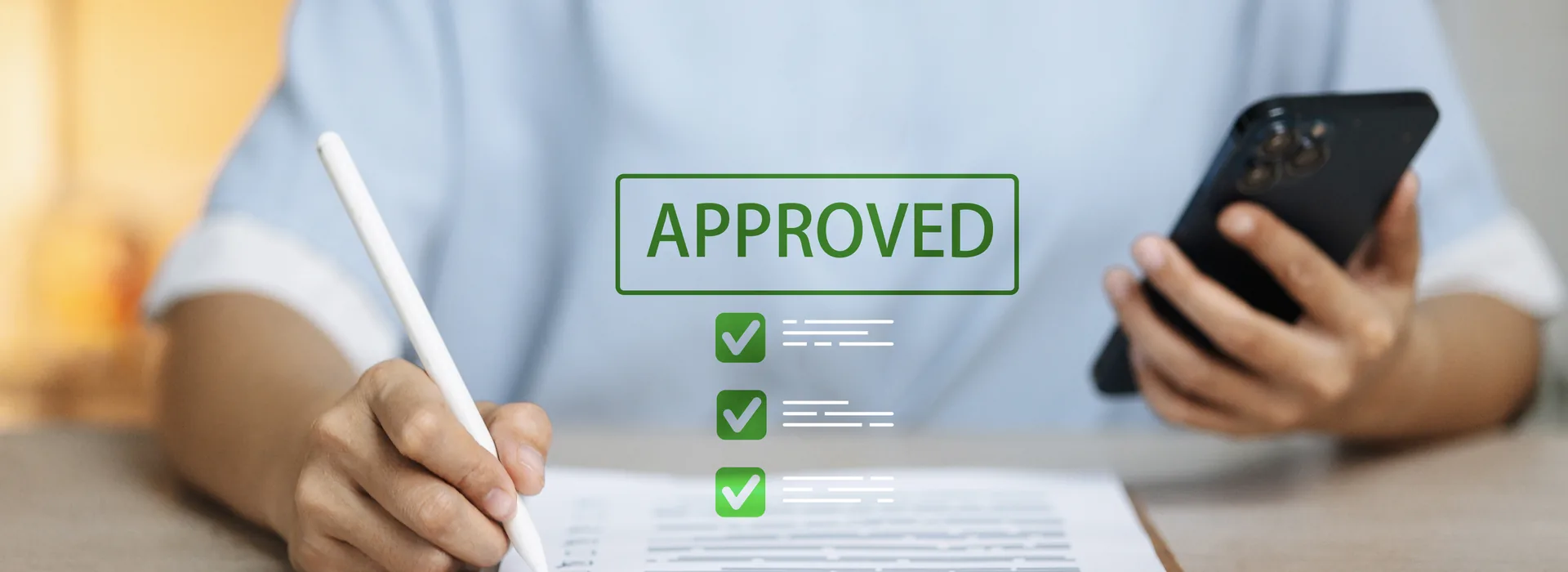 Loan application paperwork with a digital approved checklist