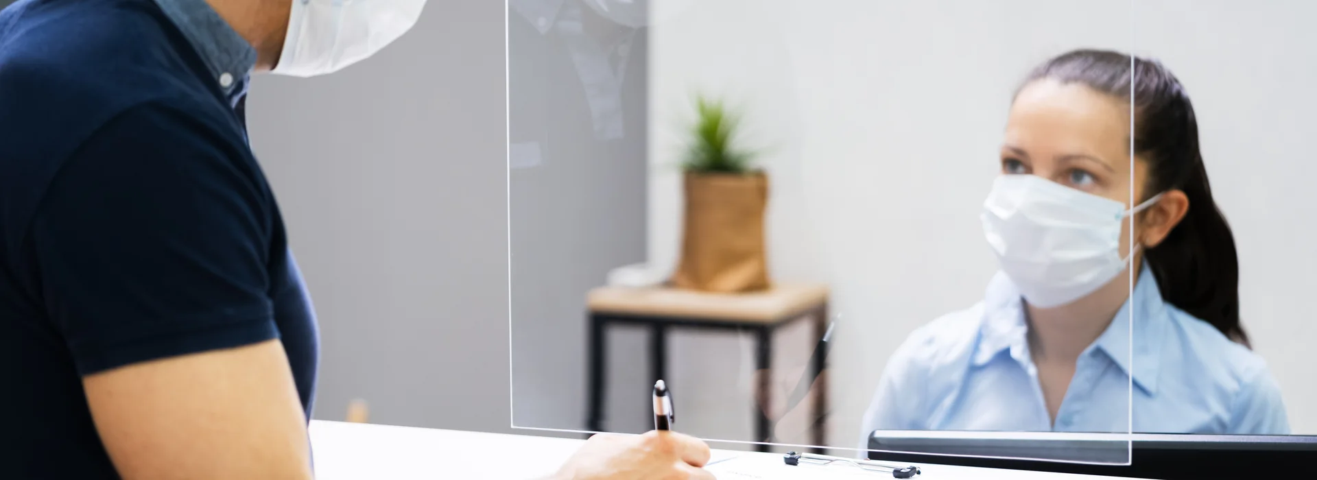 Customer signing paperwork at a financial service counter